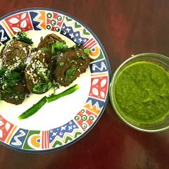 A picture of Patra with Green Chutney.