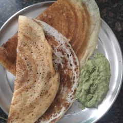 A picture of Dosa with green chutney.