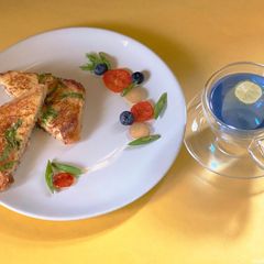 A picture of Cheesy French Toast with Butterfly Pea Lemon Tea.