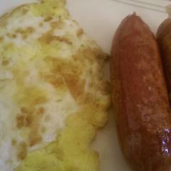 A picture of Fried egg with fried smokies.