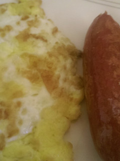 A picture of Fried egg with fried smokies.