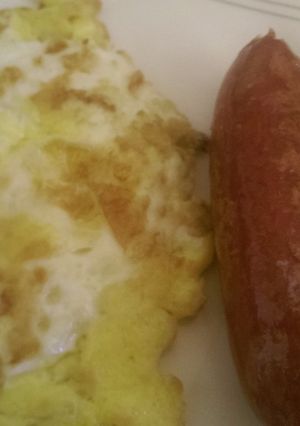 A picture of Fried egg with fried smokies.