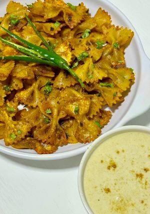 A picture of Air Fryer Masala Farfalle Chips with Cumin Yogurt Dip.