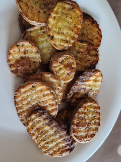 Una foto de Patatas onduladas al horno- toque italiano
