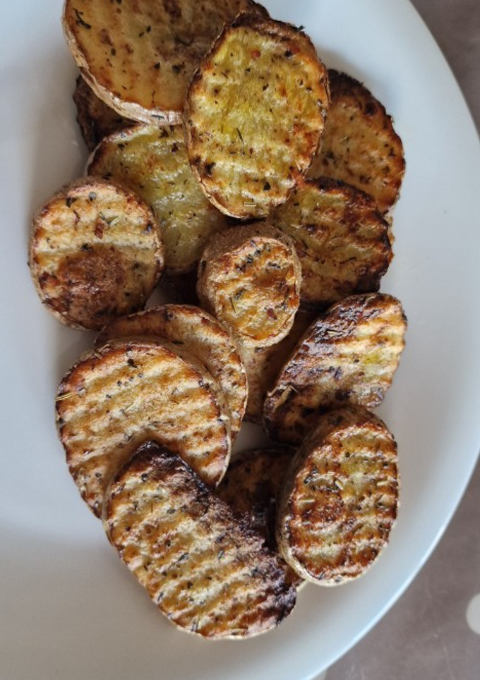 Una foto de Patatas onduladas al horno- toque italiano