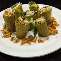 A picture of Chilli paneer stuffed spinach wrap.
