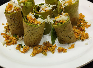 A picture of Chilli paneer stuffed spinach wrap.