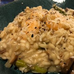 A picture of King Prawn, asparagus, and porcini mushroom risotto.