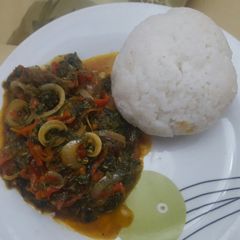 A picture of Tuwon shinkafa with fried ogu leaf.