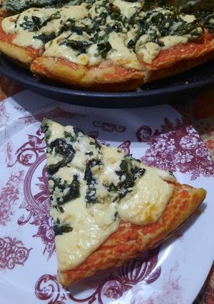 Una foto de Pizza con espinacas y salsa blanca
