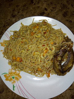 A picture of Spaghetti and macaroni jollof topped with kpanla fish😀.
