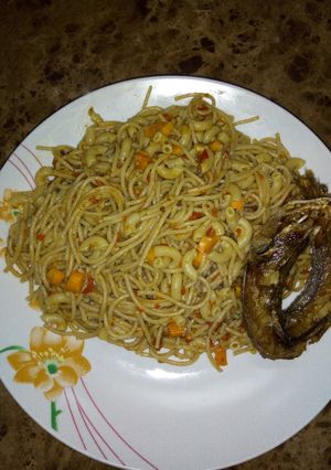 A picture of Spaghetti and macaroni jollof topped with kpanla fish😀.