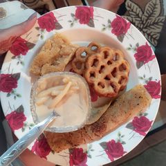 A picture of Chooshi Pither Payesh Pati Sapta Ghote Pithe and Rose Cake.