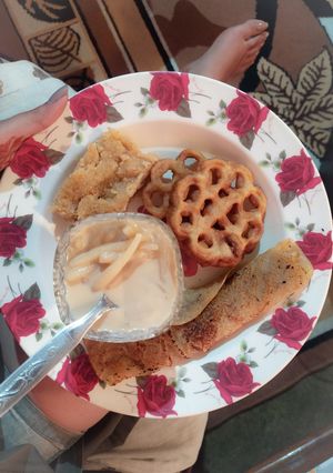 A picture of Chooshi Pither Payesh Pati Sapta Ghote Pithe and Rose Cake.