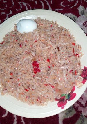 A picture of Jollof Spaghetti and macaroni with egg.