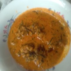 A picture of Egusi soup with palm fruits.