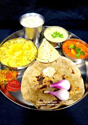 A picture of Gujarati Thali - Bajara Rotlo - Lasooni Aloo Sabzi - Khichdi - Kadhi (Dinner).