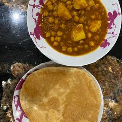 A picture of Sholay Puria/ chickpea curry with puria.