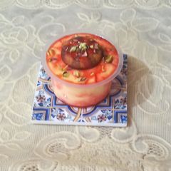 A picture of Vanilla custard with rooh afza sprinkle.