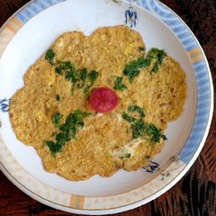 A picture of Veg omelette 🥚🥚🥬🍅.