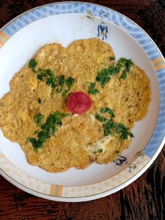 A picture of Veg omelette 🥚🥚🥬🍅.