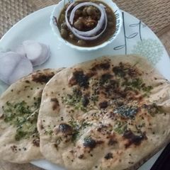 A picture of Chole and wheat kulcha.
