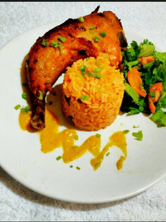 A picture of Jollof Rice with Oven Grilled Chicken and Chinese Salad.