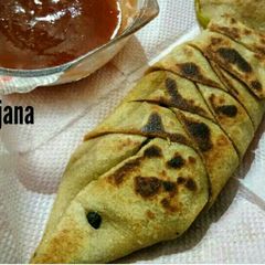 A picture of Fish wrap paratha with noodles filling.