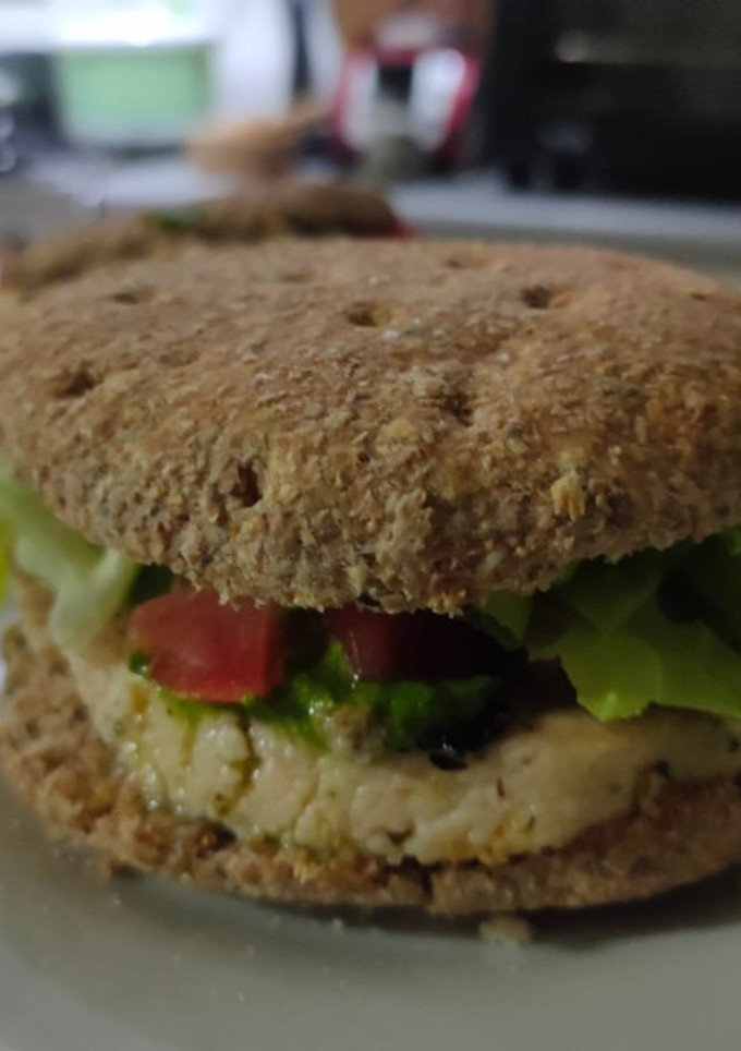 Una foto de Sándwich de pan integral, pechuga de pollo y pesto