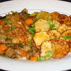 A picture of Broiled pollock with leeks and cremini mushrooms.