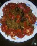 Beef pilau garnished with tomatoes