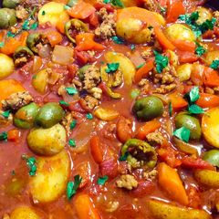 A picture of Pork ragout with paprika and green olives.