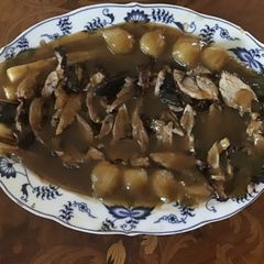 A picture of California Farm Duck in champagne with pearl and scallion onions dinner.