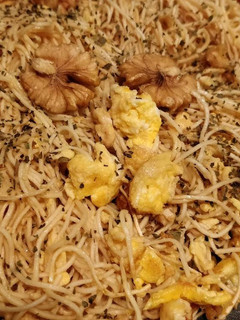 A picture of Walnut eggnuts soy source herby fried noodle.