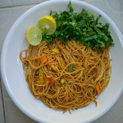 A picture of Fried spaghetti with salad.