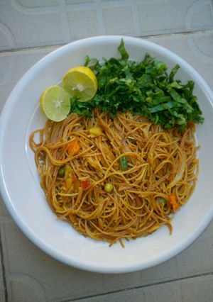 A picture of Fried spaghetti with salad.