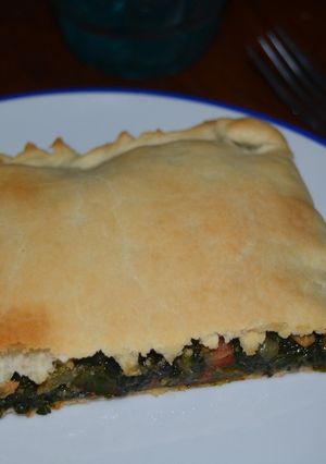 Una foto de Empanada de espinacas, trufa y parmesano