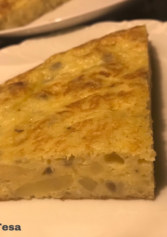 Una foto de Tortilla de patatas del cocido y cebollita roja