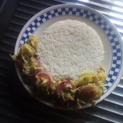 A picture of White rice with cabbage sauce.