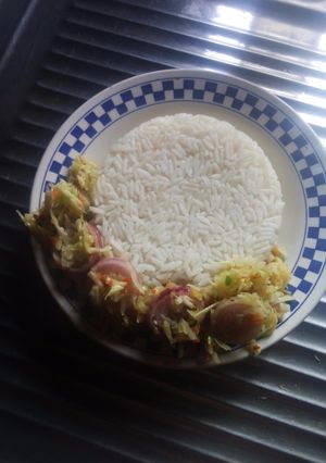 A picture of White rice with cabbage sauce.