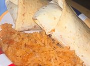 A picture of ground beef and flour tortilla burrito