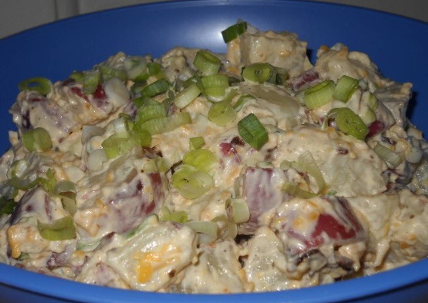 Potato salad with cheddar and pork