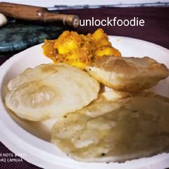 A picture of Luchi and Aloo Dum.