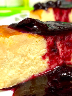 A picture of Baked Cheesecake & Blueberry Wine Sauce.