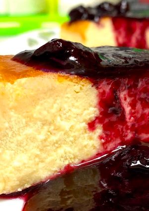 A picture of Baked Cheesecake & Blueberry Wine Sauce.