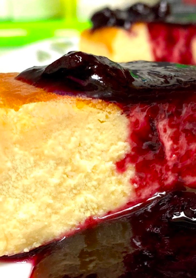 A picture of Baked Cheesecake & Blueberry Wine Sauce.