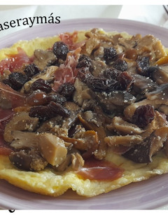 Una foto de Tortilla abierta con setas y pasas