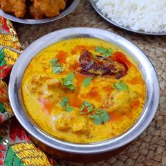 A picture of Punjabi Kadhi Pakora with Rice.
