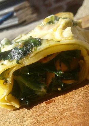 Una foto de Canelones de espinaca, jamón y queso