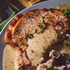 A picture of Pork Chops With A Creamy Cider & Mustard Sauce.